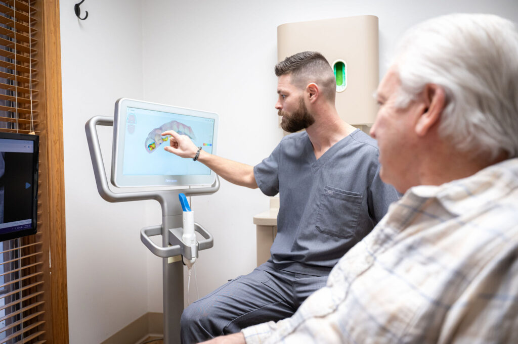 Dr. Wells explaining patient’s dental x-ray on monitor